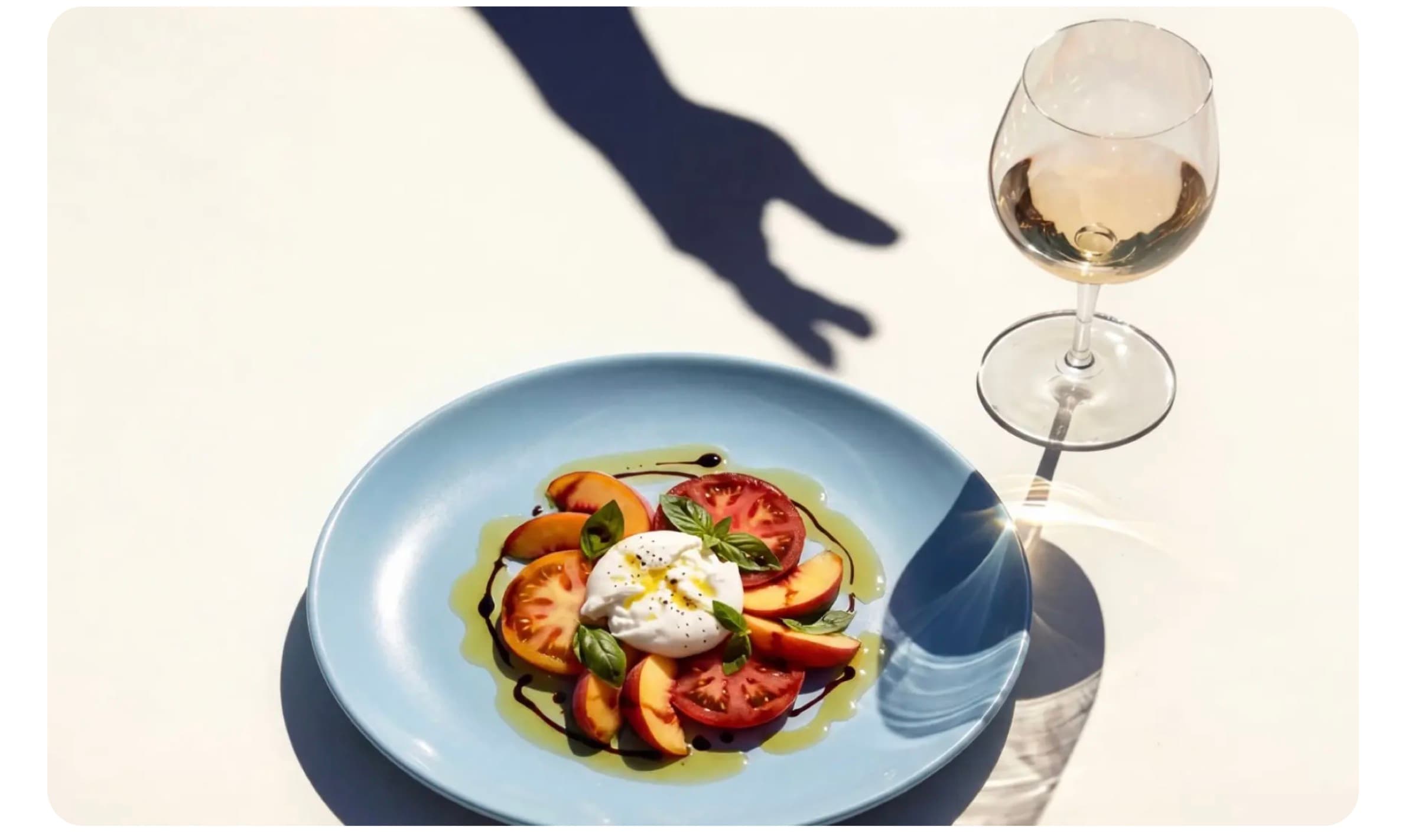 Burrata salad with rosé wine in Mediterranean sunlight